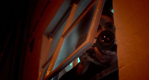 Diya looking through window